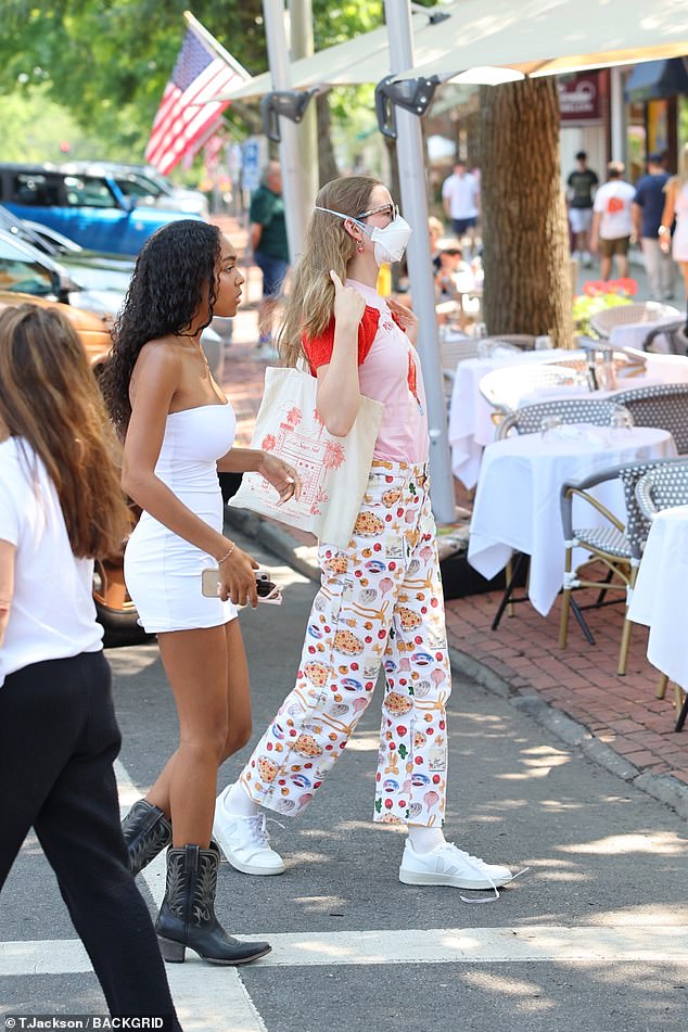 Ben Affleck's daughter wore a red and pink top, white patterned pants, and sneakers. She also wore her signature frames and a face mask