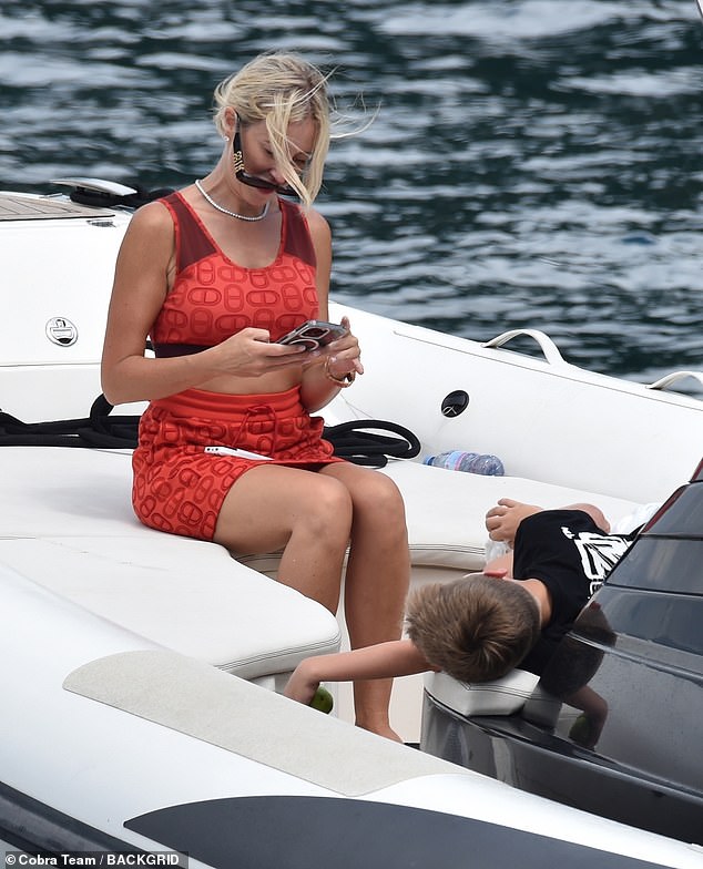 The blonde beauty was spotted taking photos of her son Hunter aboard a smaller boat