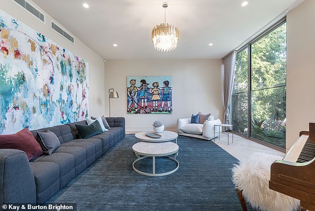 Located 13km from the CBD, the chic two-storey home features an underground 'nightclub' and lavish amenities including a travertine entrance and custom bronze doors