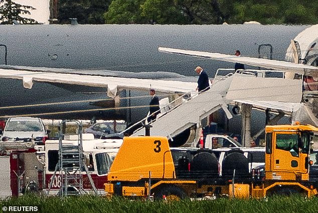 Trump descends the stairs of his plane after landing in Milwaukee