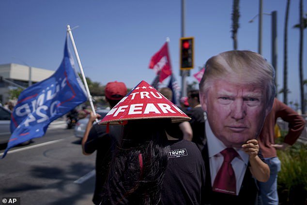 People gather in Huntington Beach, California on Sunday to show their support for Republican presidential candidate and former President Donald Trump.