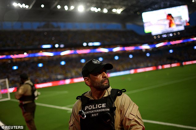 Police officers in the stadium as the match is postponed due to incidents outside the stadium