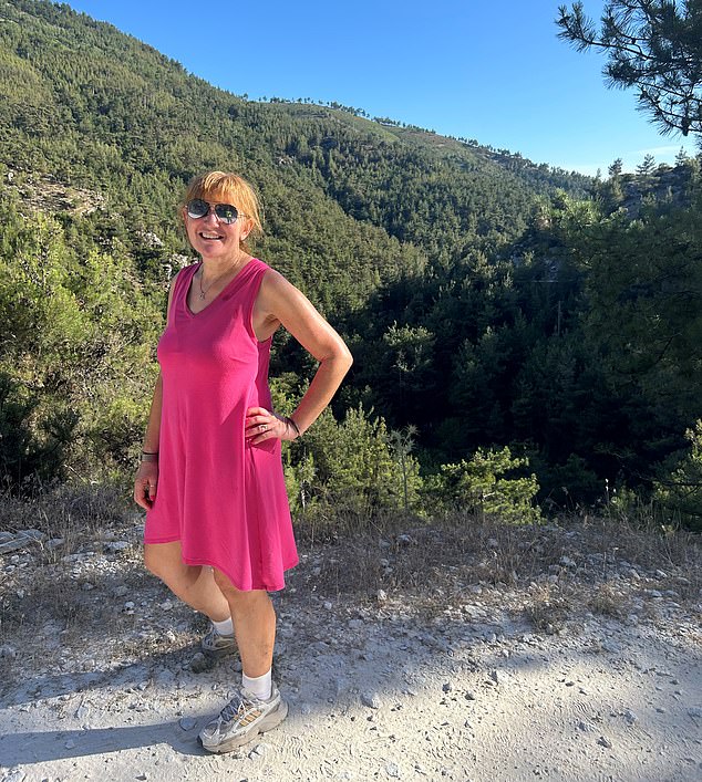 Angela poses in a pink dress while vacationing in the Greek countryside