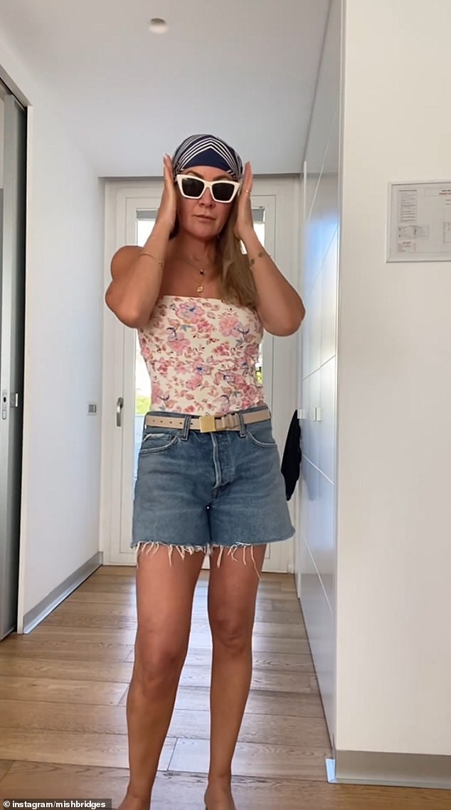 The author, who recently appeared on I'm A Celebrity... Get Me Out Of Here! Australia, dressed in a relaxed look, wearing a pair of cut-off denim shorts over her swimsuit