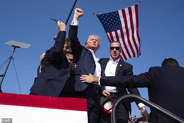 Mr. Trump raised his fist in the air before being escorted from the stage after the shooting