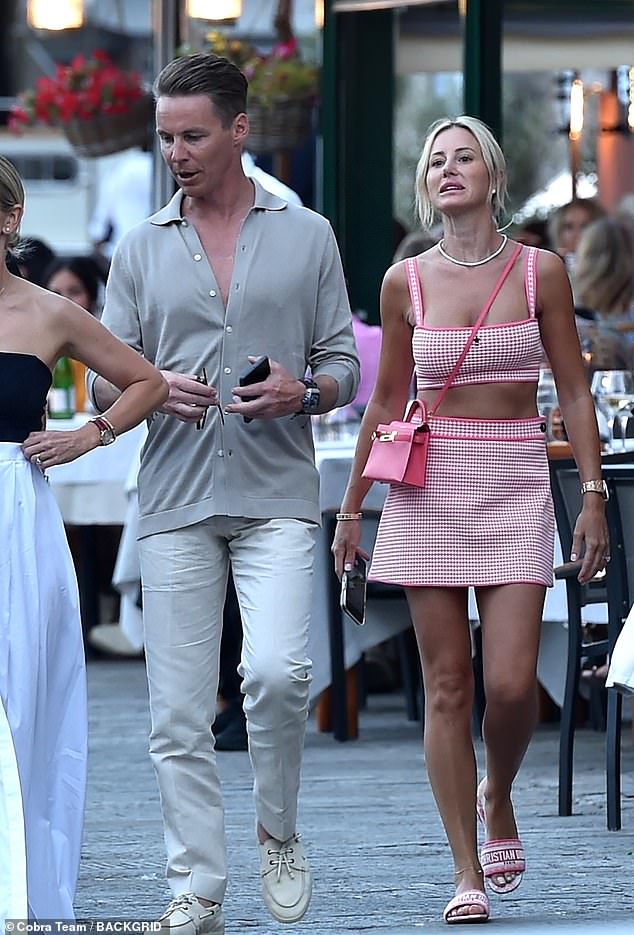 On Monday, the PR queen went on a romantic stroll in Portofino, Italy with her husband Oliver Curtis (left)