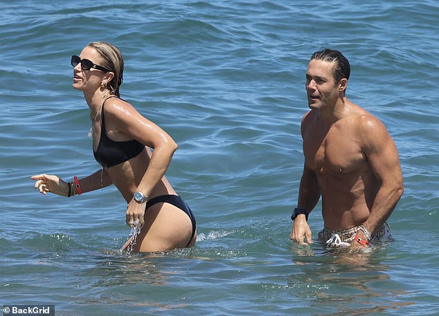 The couple, who have been married for six years, had eyes only for each other during the outing and looked in good spirits as they played in the sea