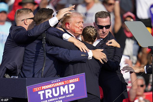 Republican presidential candidate and former President Donald Trump is helped off the stage during a campaign rally in Butler, Pennsylvania.