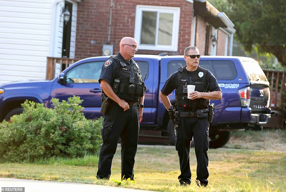 Bethel Park police officers talk outside Crooks' home Monday morning after the shooting last weekend