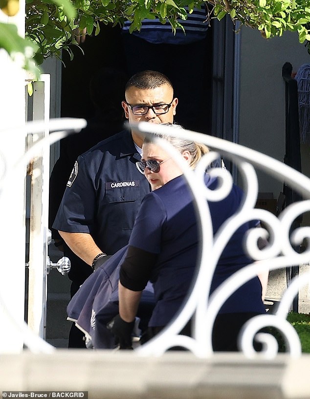 Photos show Simmons' body being removed from his West Hollywood home on Saturday