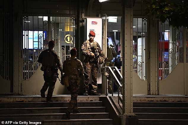 A French soldier was busy gardening the doors of the Gare de l'Est station after the attack