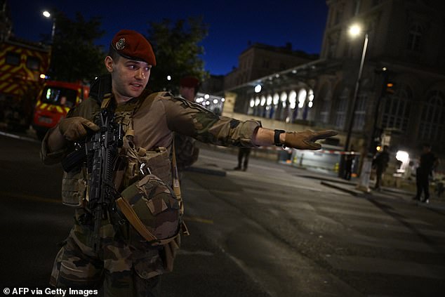 Paris is currently on the highest possible security alert as it prepares to welcome millions of people for the 2024 Summer Olympics, which begin later this month. Pictured: A soldier outside Gare de l'Est station after the stabbing