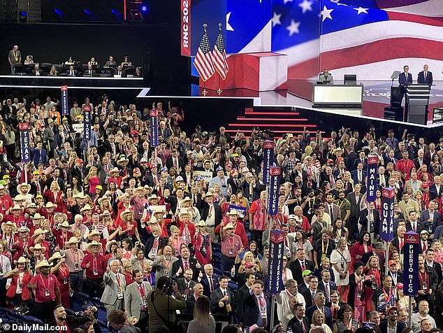 A crowd of RNC attendees smile for the cameras as the event gets underway Monday