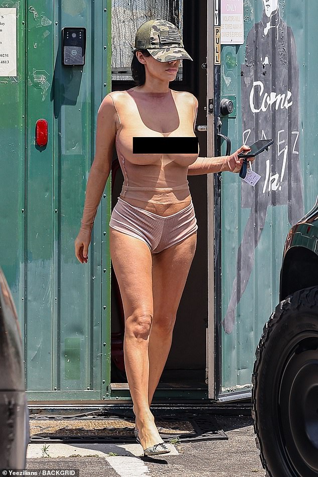 The 29-year-old Australian architect flashed her breasts in a completely sheer fishnet top as she walked into Melrose Tanning Company's salon, opting to go braless