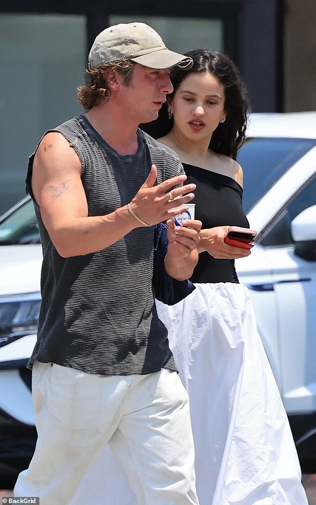 The supportive girlfriend wore a long, white bubble skirt and a black off-the-shoulder top