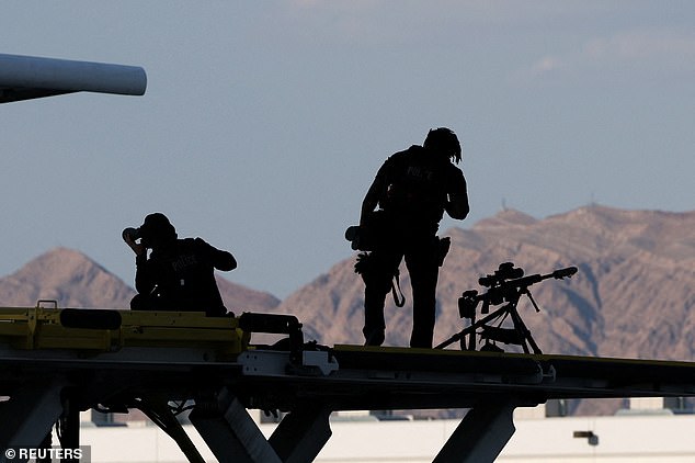 Members of the U.S. Secret Service Counter Sniper team stand guard on Air Force One at Harry Reid International Airport in Las Vegas