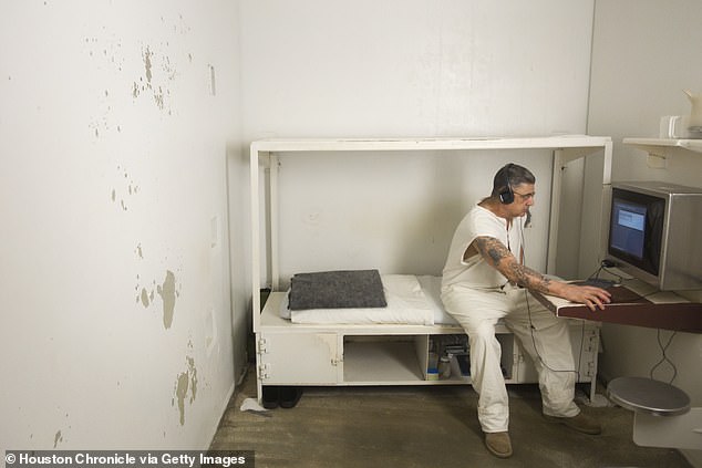 A prisoner works on a computer in his cell in the administrative segregation wing of the Estelle Unit (file photo)