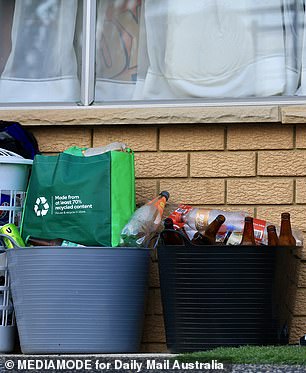 Bottles were stacked outside the Marsfield home and there were several safety signs about a dog and cameras