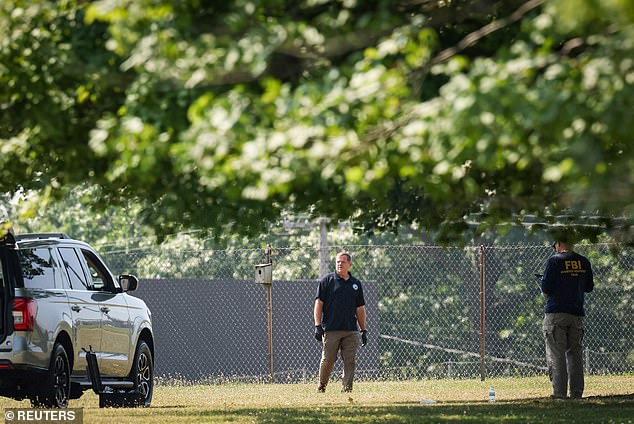 Members of the FBI Evidence Response Team work near the building where Crooks was shot and killed by police