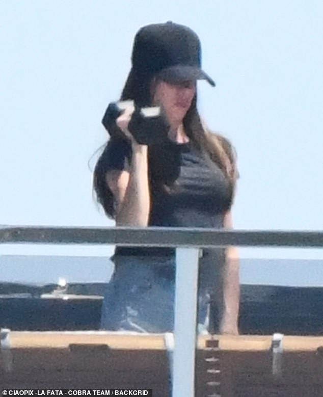 She was photographed lifting weights on the yacht, and doing her exercises on the sun deck, while dressed casually in a plain black T-shirt and denim shorts.