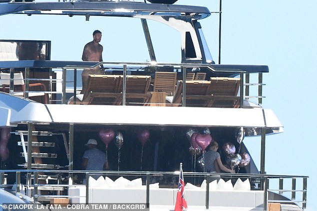 The family celebrated by hanging pink and silver balloons, with Harper taking pride of place as she enjoyed breakfast with her siblings Romeo, 21, and Cruz, 19.