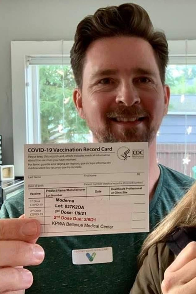 Stuart Eivers is pictured above holding his Covid vaccination card