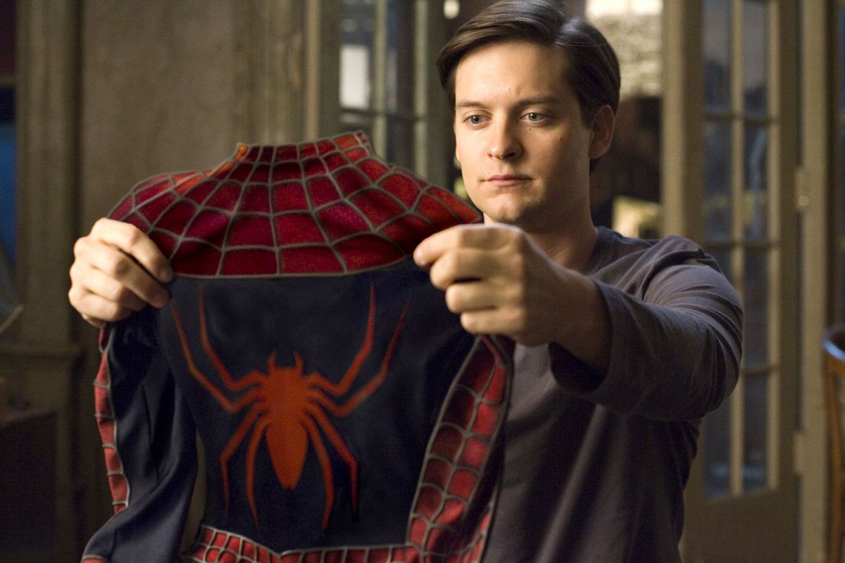 Peter Parker (Tobey Maguire) holds up his Spider-Man costume in Spider-Man 3