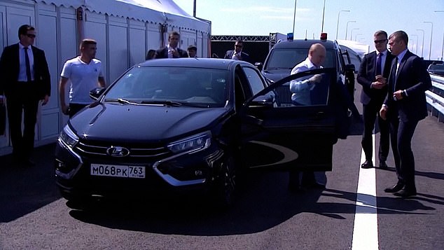 As he stepped out of the vehicle after the near-crash, Putin's security team swarmed around him