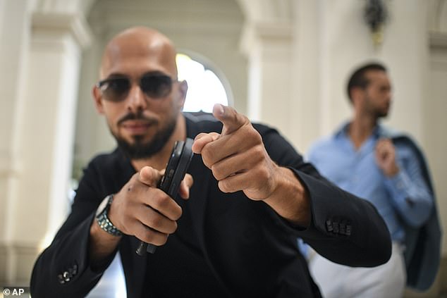 Tate poses outside the Bucharest Court of Appeal before the court overturned a July 5 ruling that allowed him and his brother to leave Romanian territory, on condition he remain within the European Union, while he awaits trial on charges of human trafficking, rape and forming a criminal gang to sexually exploit women.