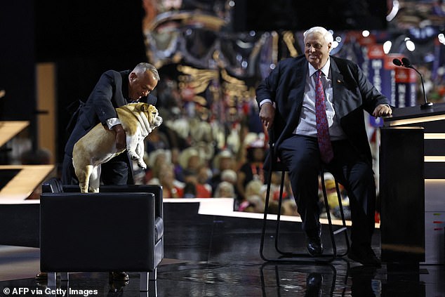 Governor Jim Justice (right) sat during his speech at Congress and had an attendant lay Babydog down next to him