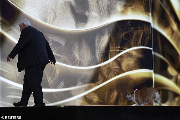 West Virginia Governor Jim Justice leaves the stage, followed by Babydog, Tuesday night during the Republican National Convention in Milwaukee