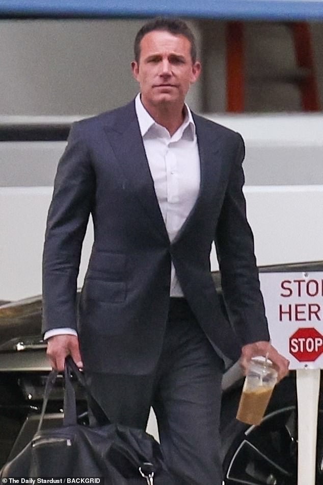 The 51-year-old actor and director was spotted arriving at his LA office earlier on Tuesday in a suit, carrying a gym bag