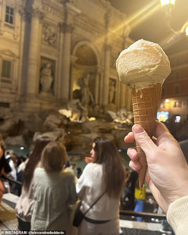 The final photo was a close-up of a hand holding up the treat in front of a statue, as she captioned the carousel: 'A Roman gelato monster'