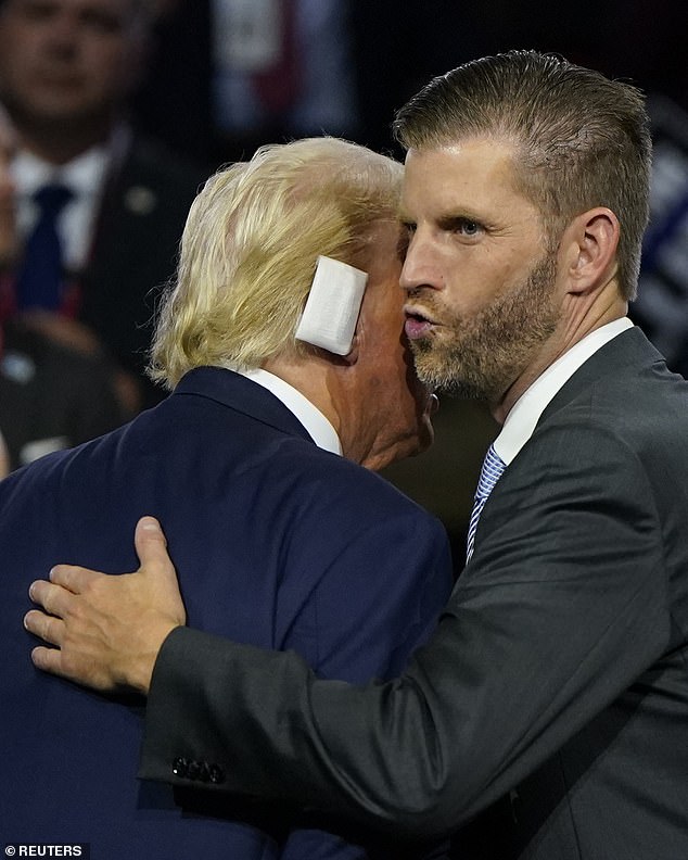 Eric Trump hugs his father in the private box of the Republican convention, three days after the failed assassination attempt