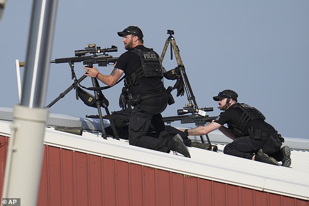 Police snipers return fire after shots were fired while Republican presidential candidate and former President Donald Trump spoke at a campaign rally