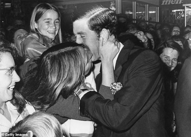 Prince Charles receives a kiss from 16-year-old Gilda Larbey while walking on the Mall, Perth, Western Australia, November 1977