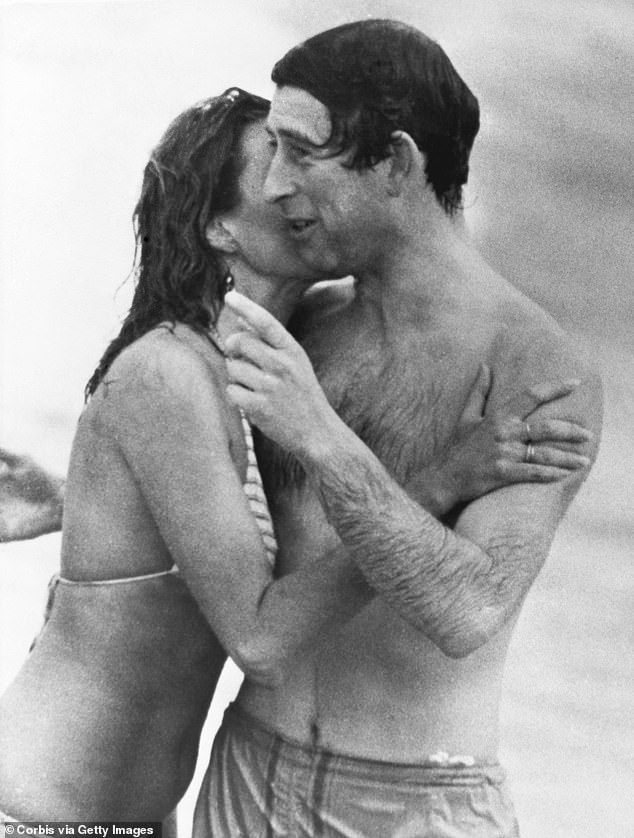 Prince Charles is kissed by Jane Priest, a model, as he emerges from the water at Cottesloe Beach in Perth, during his tour of Australia in 1979