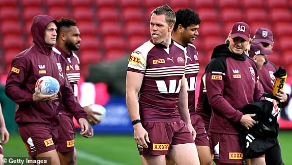 BRISBANE, AUSTRALIA - JULY 16: Lindsay Collins and teammates walk onto the field during a run by the Queensland Maroons captain at Suncorp Stadium on July 16, 2024 in Brisbane, Australia. (Photo by Bradley Kanaris/Getty Images)