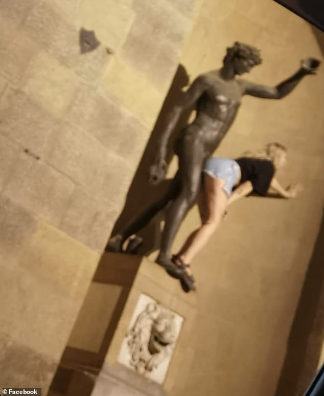 The smiling woman, dressed in jeans and a black T-shirt, also stood in front of the statue, rubbing her bottom against it as her friend took photos