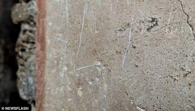 In June, an anonymous vandal was arrested while he was carving 'Ali' on light plasterwork in the House of the Ceii (photo)