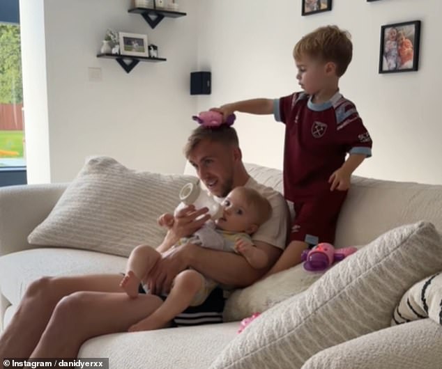 In the adorable clip, Jarrod, who shares twins Summer and Star, 13 months, with Dani, is seen feeding one of the little ones while the Love Island star's son Santiago, three, brushes his hair