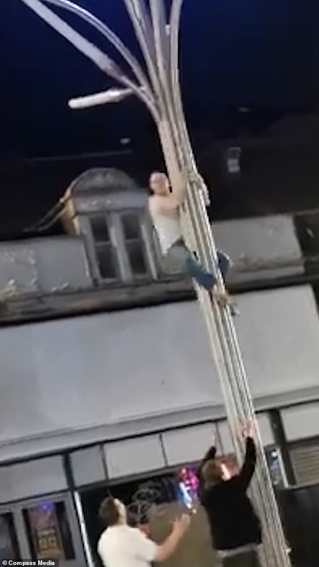 After giving a quick double fist pump celebration, he swings his legs back and does a style move as he slides safely down the pole to the floor