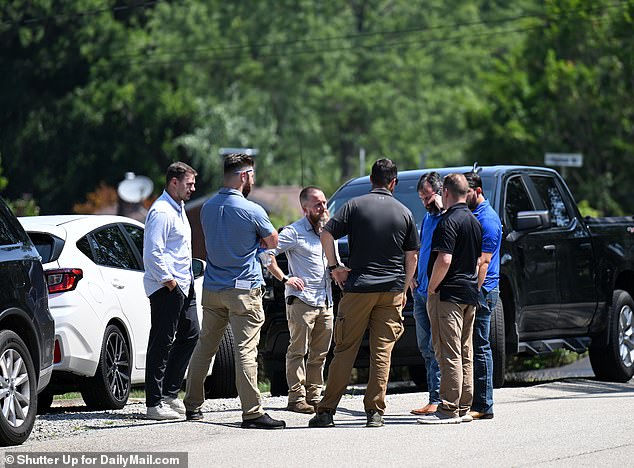 FBI agents knock on doors of neighbors around the shooter's Bethel Park home Monday as they interview locals