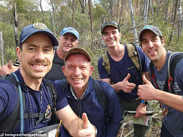 Tony Abbott is pictured, second from left in the foreground, on an expedition with a member of the Royal Fire Brigade last year