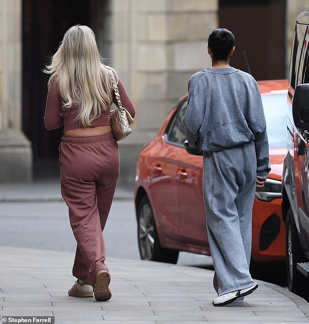 She completed the casual ensemble with a pair of beige striped sneakers and styled her blonde locks in bouncy waves for the outing