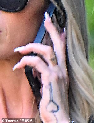 The star showed off her hand tattoo - which looked like it was being removed - and her ring-less finger