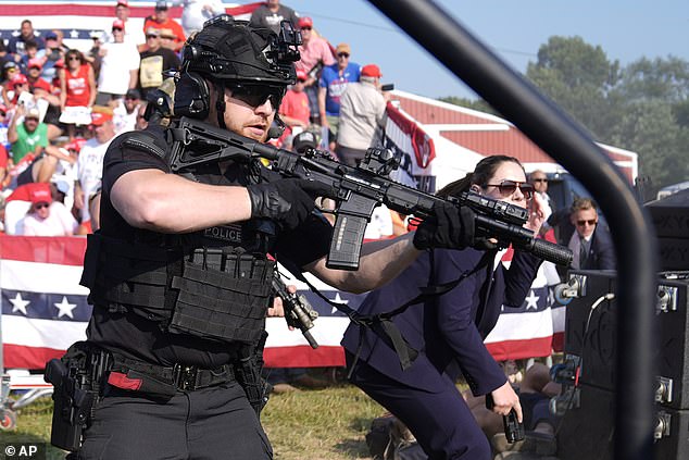 U.S. Secret Service agents surround the stage as other agents keep an eye on Republican presidential candidate and former President Donald Trump during a campaign rally,