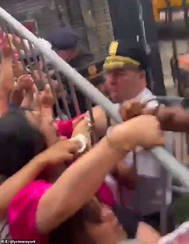 Police could be seen struggling with Zhuang and several other protesters over a metal barricade, at one point appearing to lift it