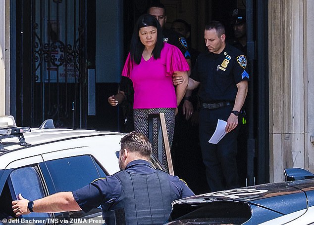 Brooklyn City Councilmember Susan Zhuang, arrested during a protest, is taken by officers from the 62nd precinct in Bath Beach for transport to Brooklyn Central Booking