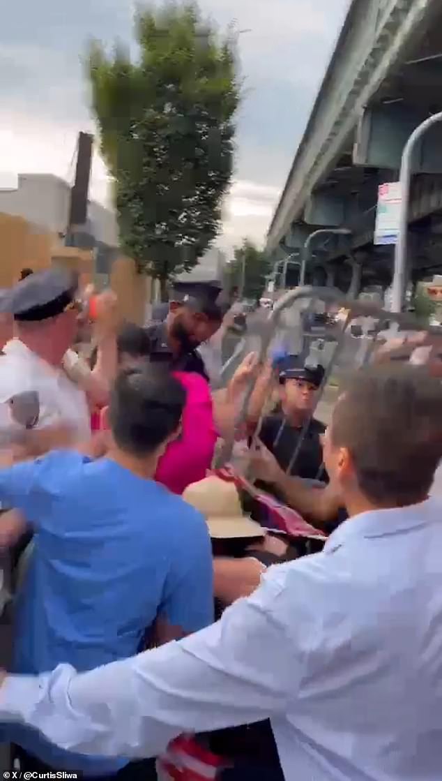 Barricades can be seen in the air during the clash between protesters, with Zhuang seen in pink